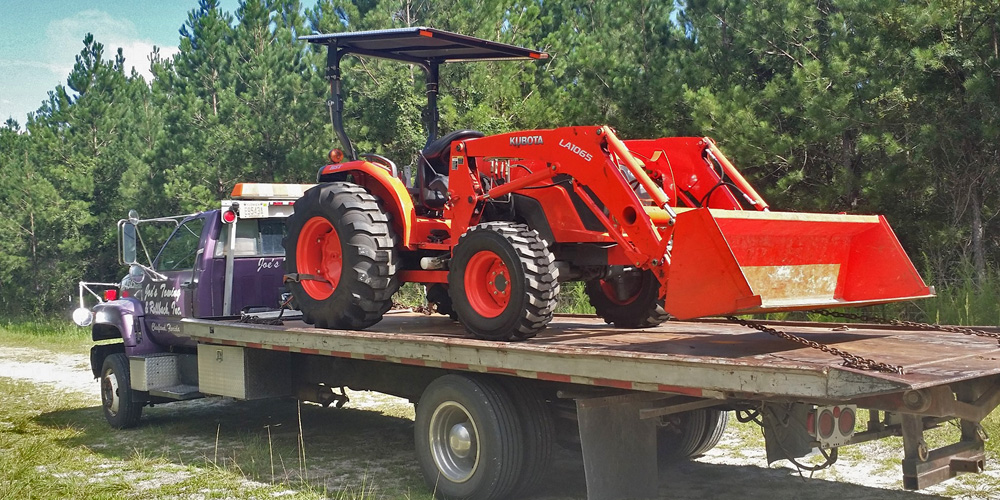 Image Of Kubota Tractor Being Towed